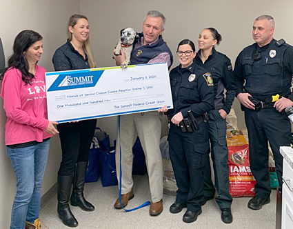 The Summit and Syracuse Law Enfocement present check to Second Chance Canine Adoption Center.
