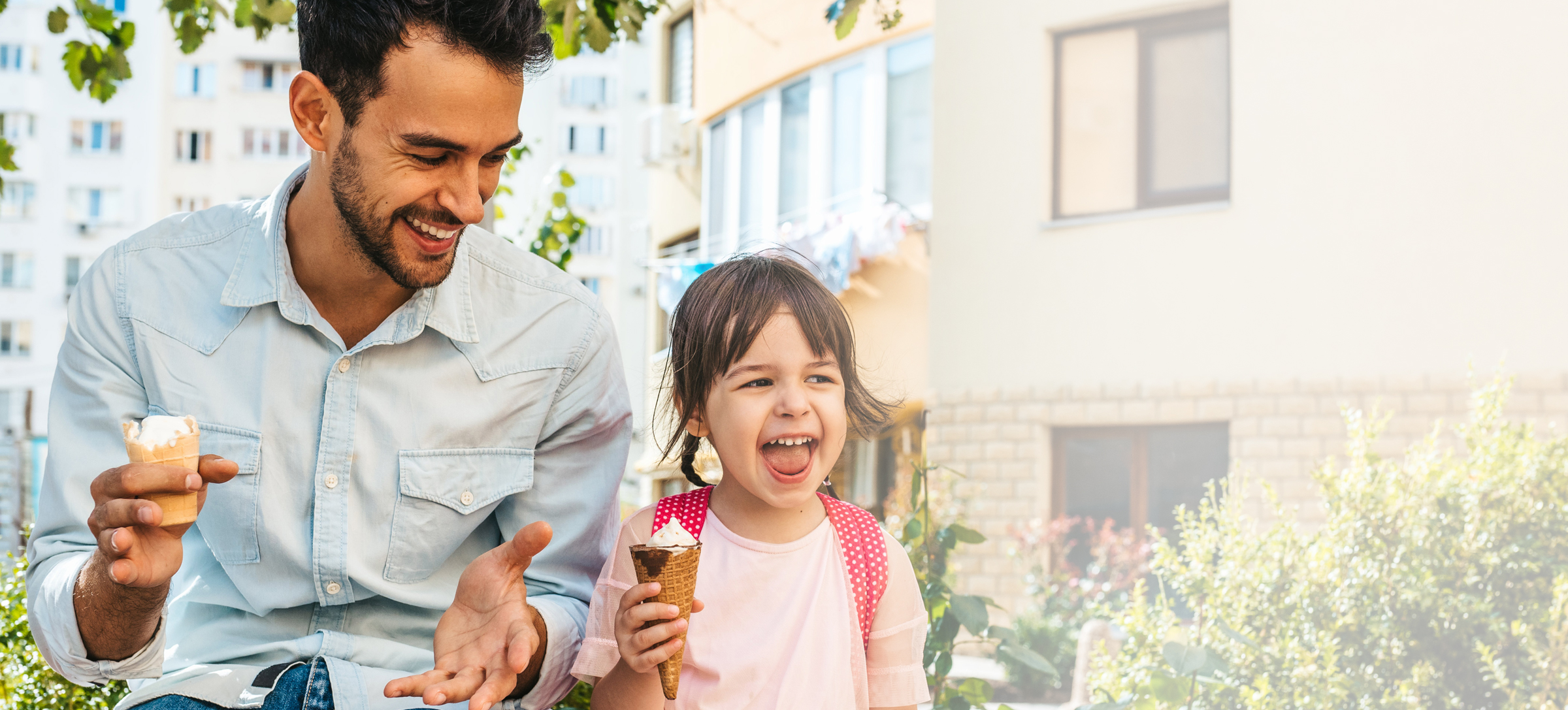 father and daughter enjoy ice cream outside
