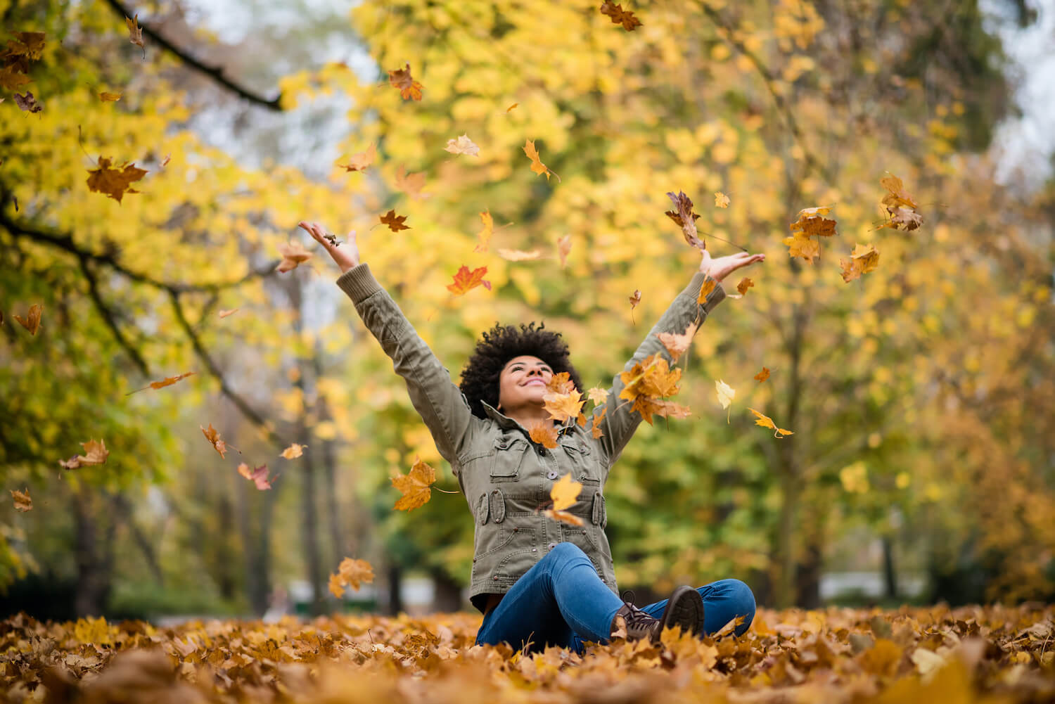 woman playing in leaves