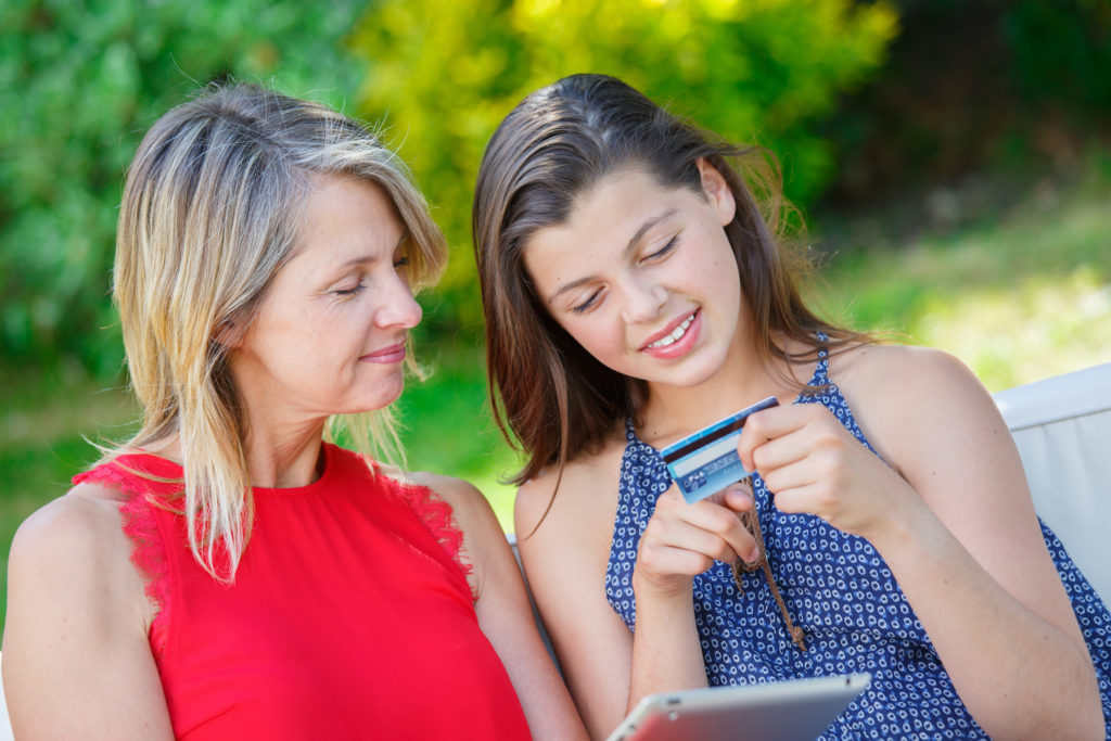 mother and daughter making purchase on tablet