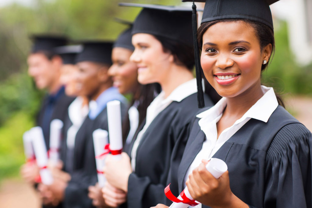 Happy graduates in line outside. Student loans homepage banner