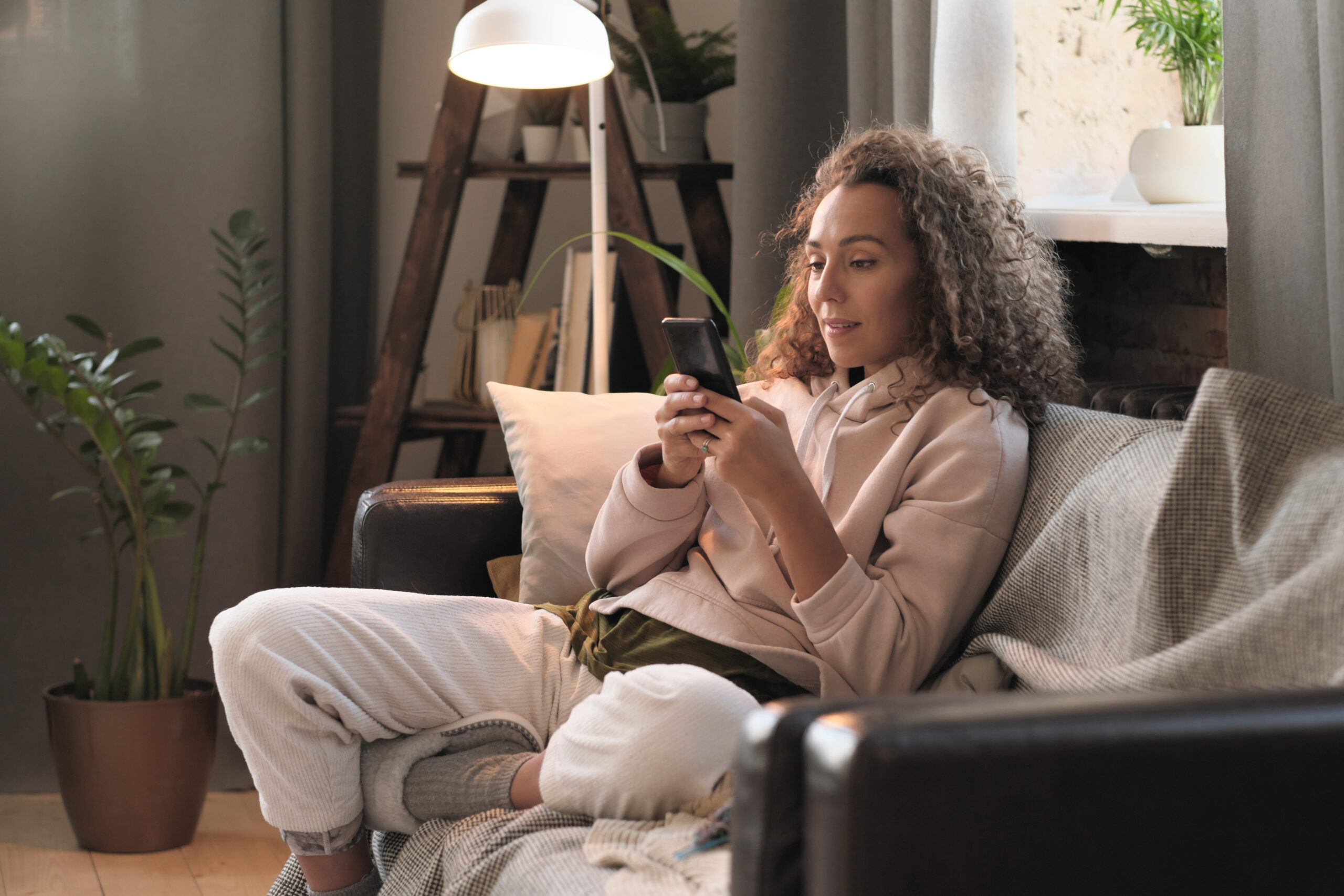 woman using phone at home